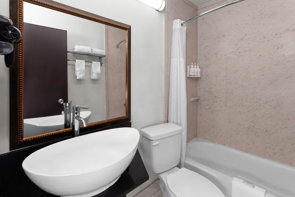 Bathtub and shower in a king guest room at Travelodge by Wyndham Milwaukee