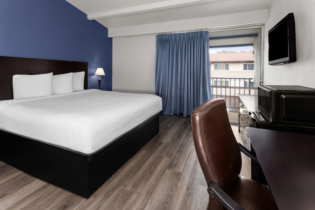 King bed guest room with balcony at Travelodge by Wyndham Milwaukee