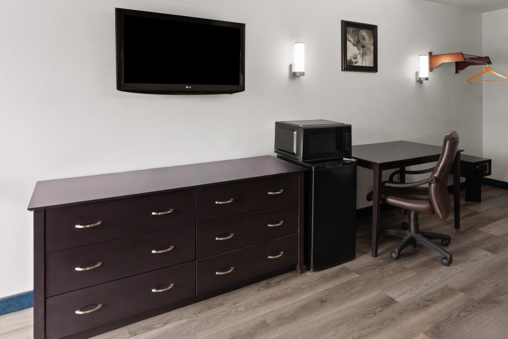 King bed guest room with work desk and HDTV at Travelodge by Wyndham Milwaukee