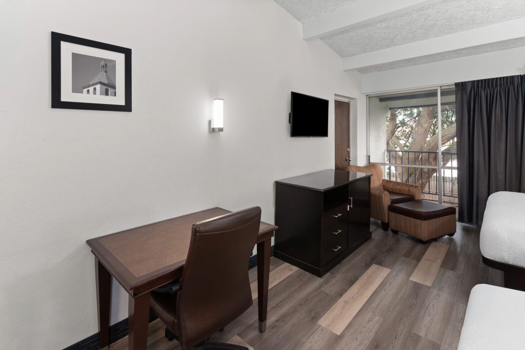 Two queen beds with work desk and HDTV at Travelodge by Wyndham Milwaukee