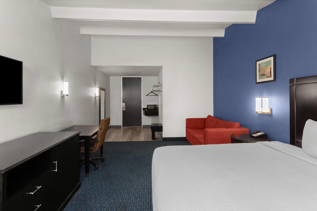 King studio suite seating area and work desk at Travelodge by Wyndham Milwaukee