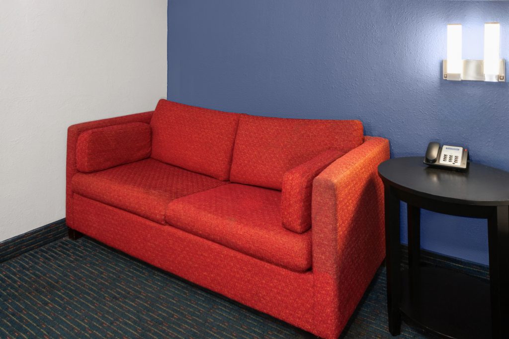 Sofa bed seating area in the king studio suite at Travelodge by Wyndham Milwaukee