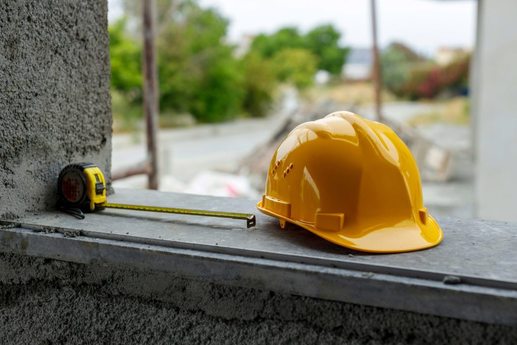 Tape measure and hard hat on a construction site — Travelodge by Wyndham Milwaukee construction crew rates